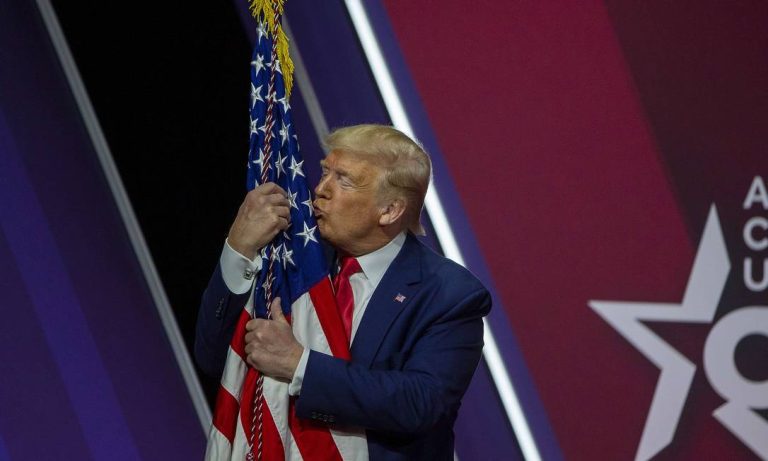 87283810_NATIONAL-HARBOR-MARYLANDFEBRUARY-29-President-Donald-Trump-kisses-the-flag-of-the-United